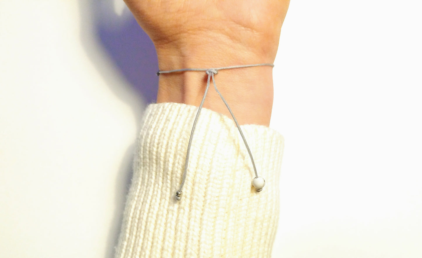 Delicate bracelet with stainless steel, gemstone pendant and textile cord